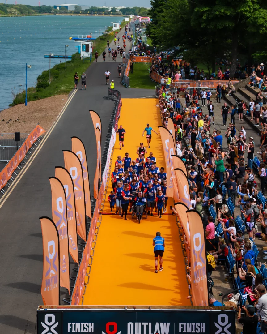 The orange carpet awaits at the finish line of the Outlaw Triathlon, consistently ranked as one of the best triathlon races in the world bucket list triathlon.
